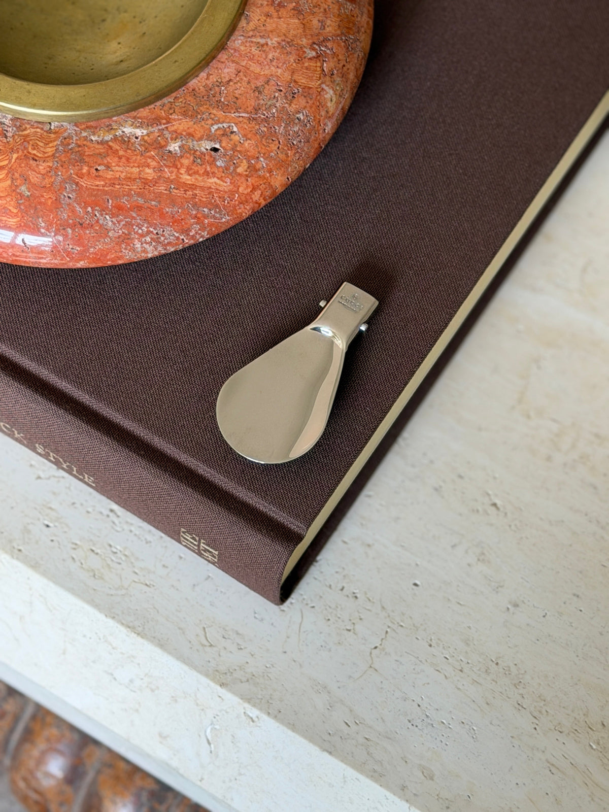 Fully extended Gucci folding travel shoehorn showing the polished metal blade