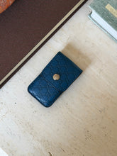 Overhead view of the blue leather Gucci monogram case for the shoehorn