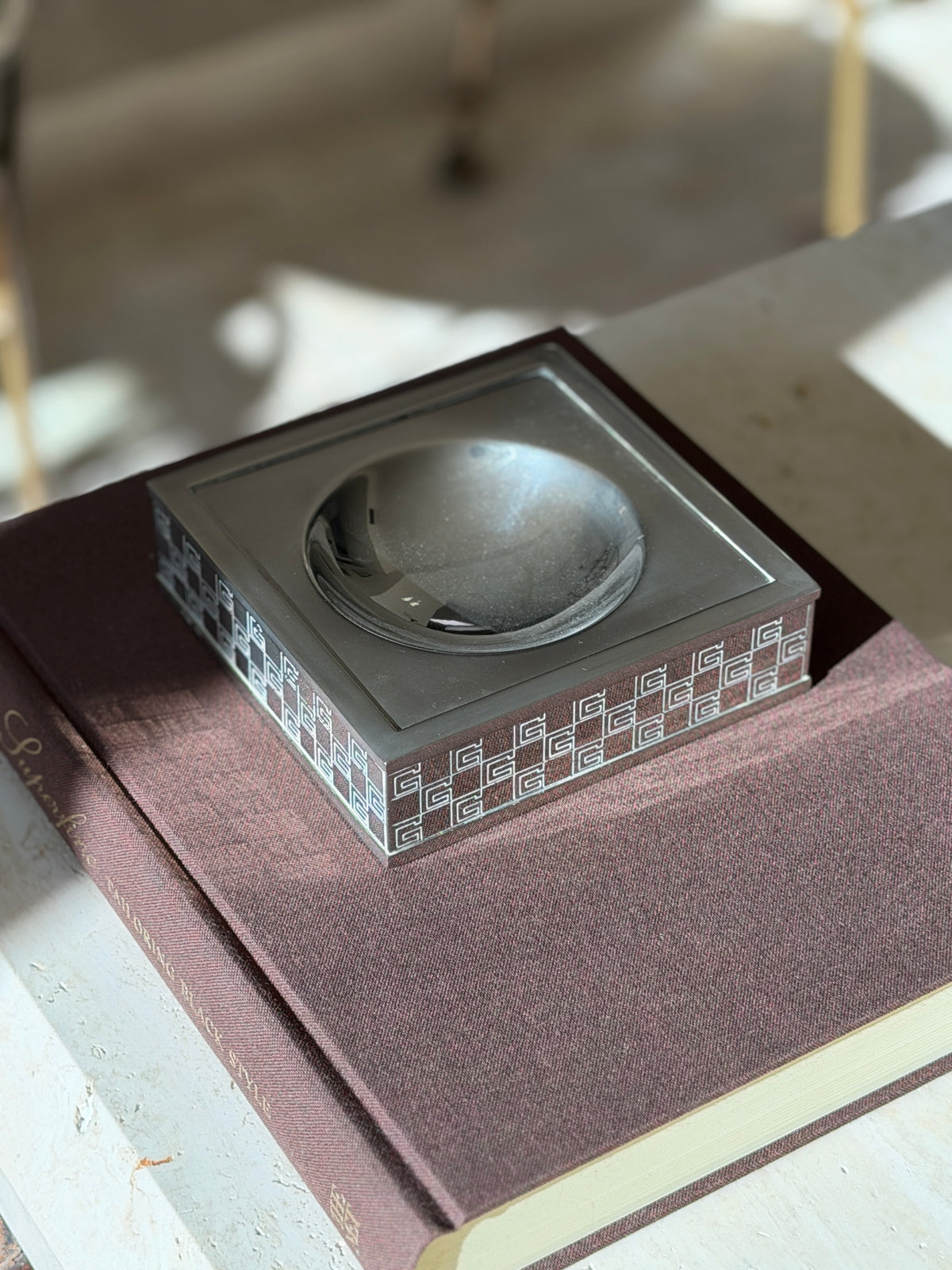 Gucci G vide poche on the Superfine book in soft sunlight, the polished dish reflecting the room