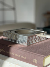 Low side view of the Gucci catchall showing the engraved G monogram band wrapping all four silver sides