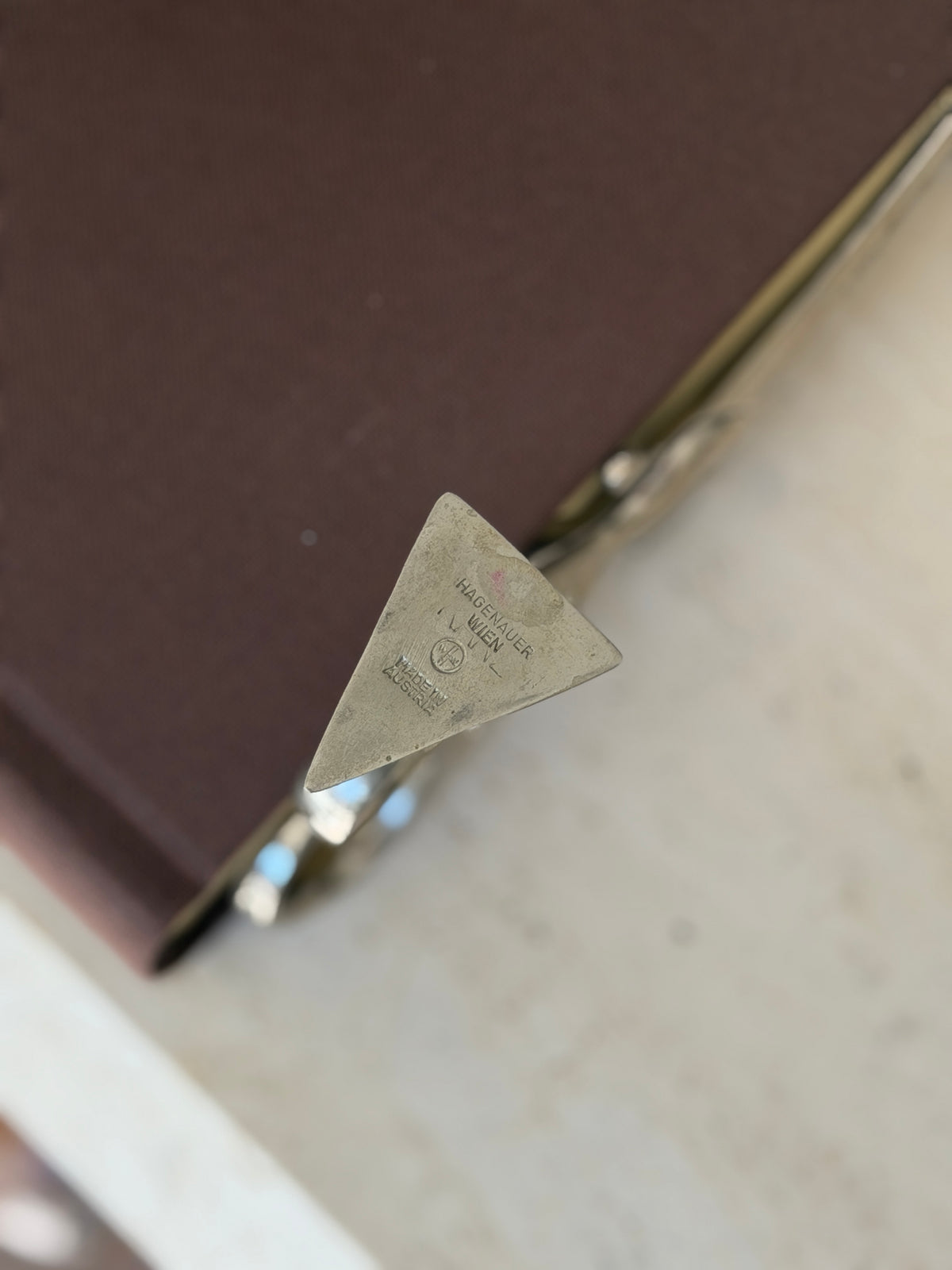 Close view of the triangular foot stamped Hagenauer Wien with the WHW monogram and Made in Austria mark