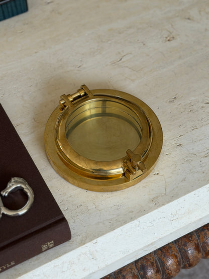Close-up of the wing nut latch mechanism on the side of the box, showing the brass hinge and screw closure in detail