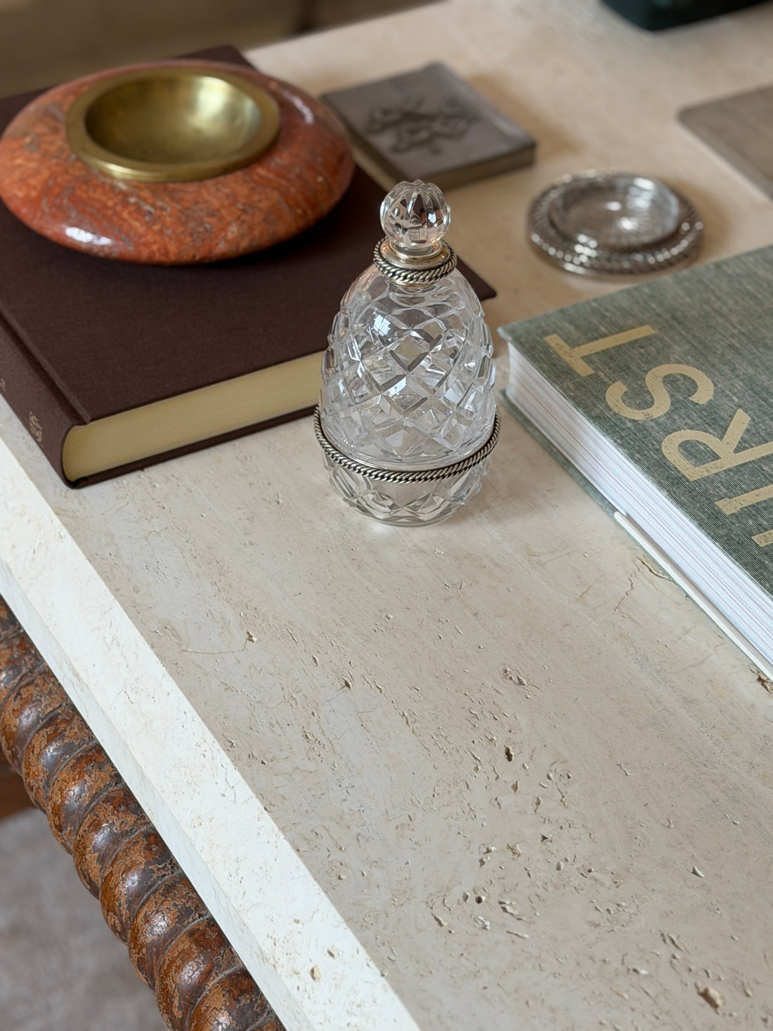 Front view of the Hermes crystal bottle with its silver rope-twist neck mount