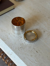 Hermes cigarette box opened with the lid set aside, revealing a gilt interior divided into four compartments by crossed partitions