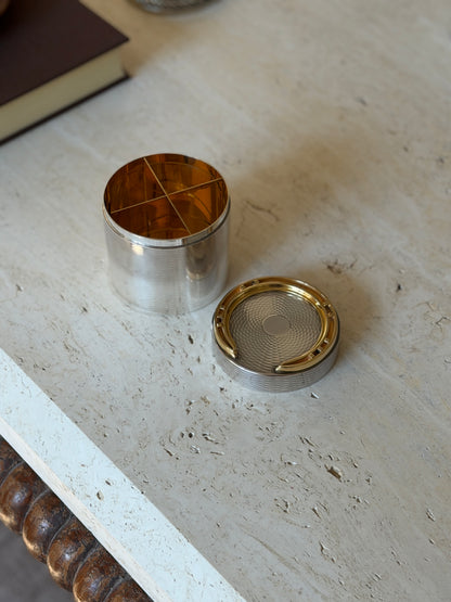 Hermes cigarette box opened with the lid set aside, revealing a gilt interior divided into four compartments by crossed partitions