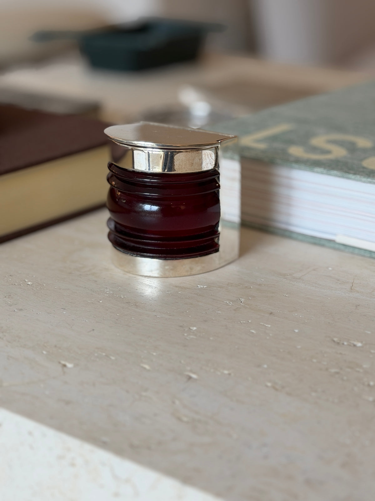 Front view of the closed Hermes boat light box styled among desk accessories