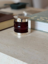 Front view of the closed Hermes boat light box styled among desk accessories
