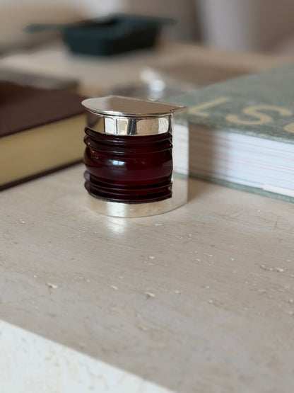 Front view of the closed Hermes boat light box styled among desk accessories