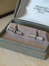 Closer view of the Hermes cable cufflinks in the box, showing the deeply textured twisted strands and polished wrapping band