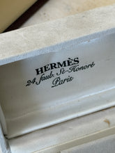Close up of the satin lid lining printed Hermes 24 Faubourg Saint Honore Paris inside the pale gray suede cufflink box