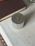 Hermes solid silver lidded box with a gilt horse on the lid, its body engine turned with fine wavy lines, on travertine beside a brown book