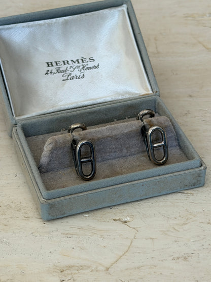 Front view of the original Hermes box holding both anchor chain cufflinks upright on the cushion