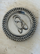 Hermes equestrian money clip centered in a silver dish ringed with heavy curb chain