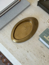 Direct top-down view of low profile Italian bronze oblong vide poche dish styled on travertine surface at Collectors Gene