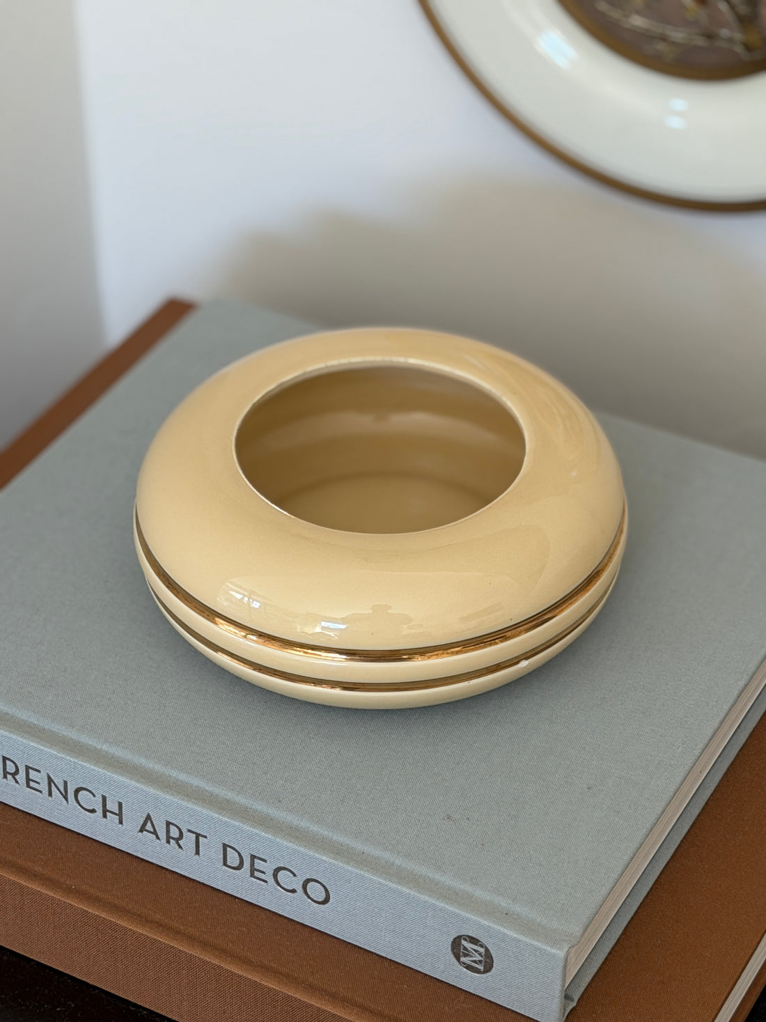 High angle view of round cream and gold Space Age ceramic vide poche dish available at Collectors Gene