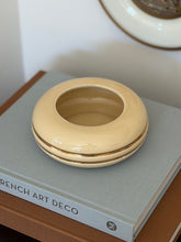High angle view of round cream and gold Space Age ceramic vide poche dish available at Collectors Gene