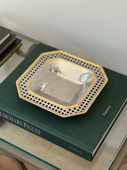 Angled perspective view of 1980s Italian silver-tone catchall with gold trim and pierced geometric border from Collectors Gene