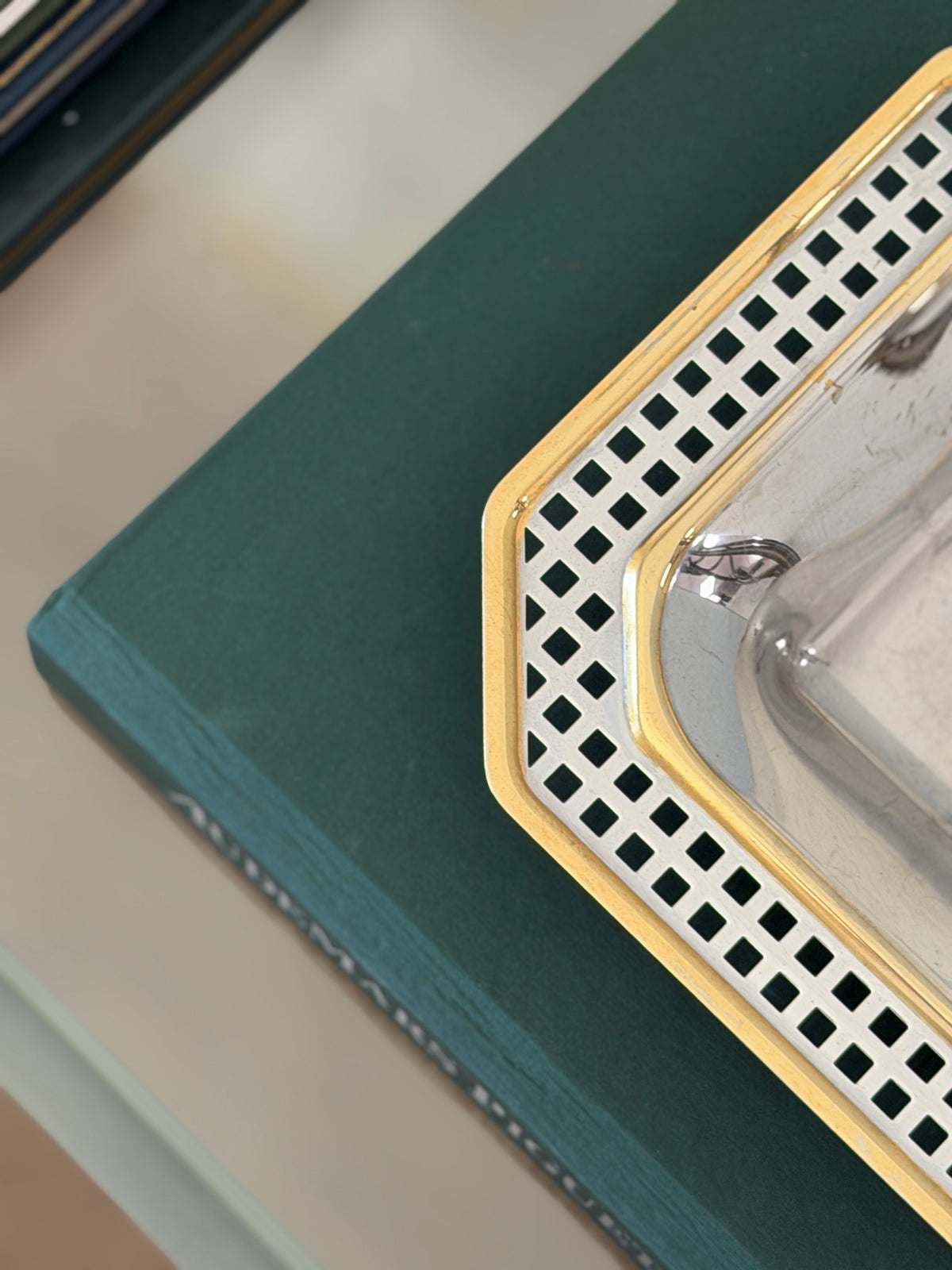 Close-up view of gold-tone edging and pierced rectangular openings on vintage Italian metal catchall from Collectors Gene