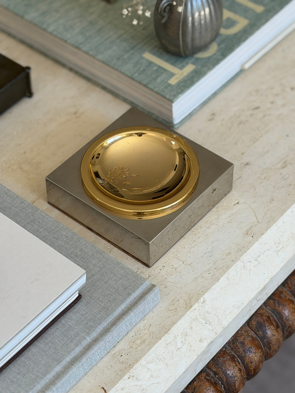 Curated executive desk scene featuring vintage 1970s Italian mixed-metal vide poche catchall at Collectors Gene