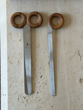 Italian scissors and letter opener laid out together, their matching round wood handles and long brushed steel blades shown in full length