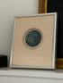 Framed Nightbird mezzotint leaning on a white shelf beside a small dark box and a gilt framed painting