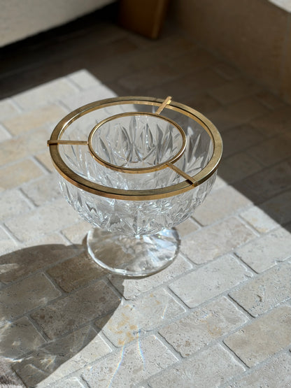 Angled view of the English cut crystal caviar dish, the gilt bridge bars suspending the inner bowl above the outer ice well