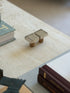 Angled desk shot of two silver modernist wine bottle stoppers with natural cork bottom by Collectors Gene