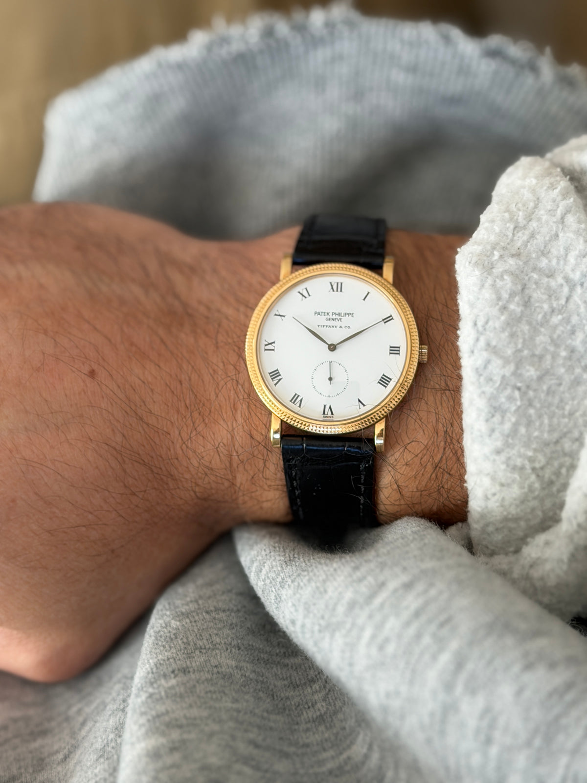 Close-up of the Calatrava on the wrist with the dial upright, showing the Patek Philippe Geneve and Tiffany and Co signatures and the small seconds subdial