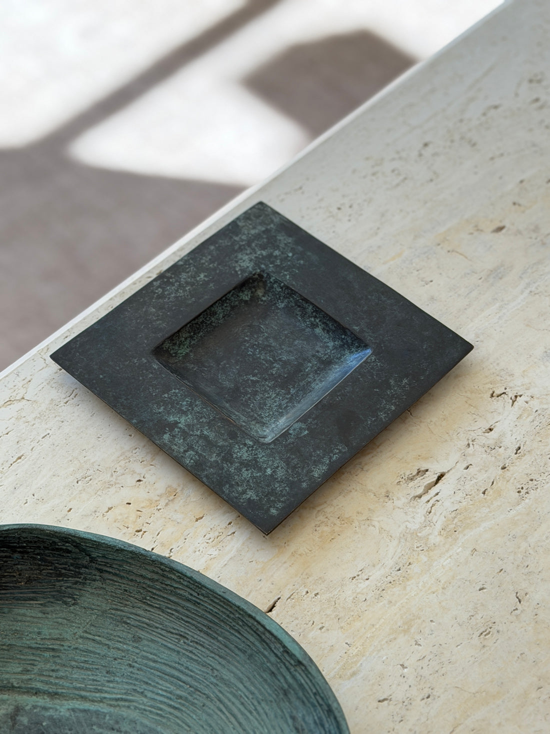 High angle view of square dark verdigris bronze catchall dish with recessed center by Collectors Gene