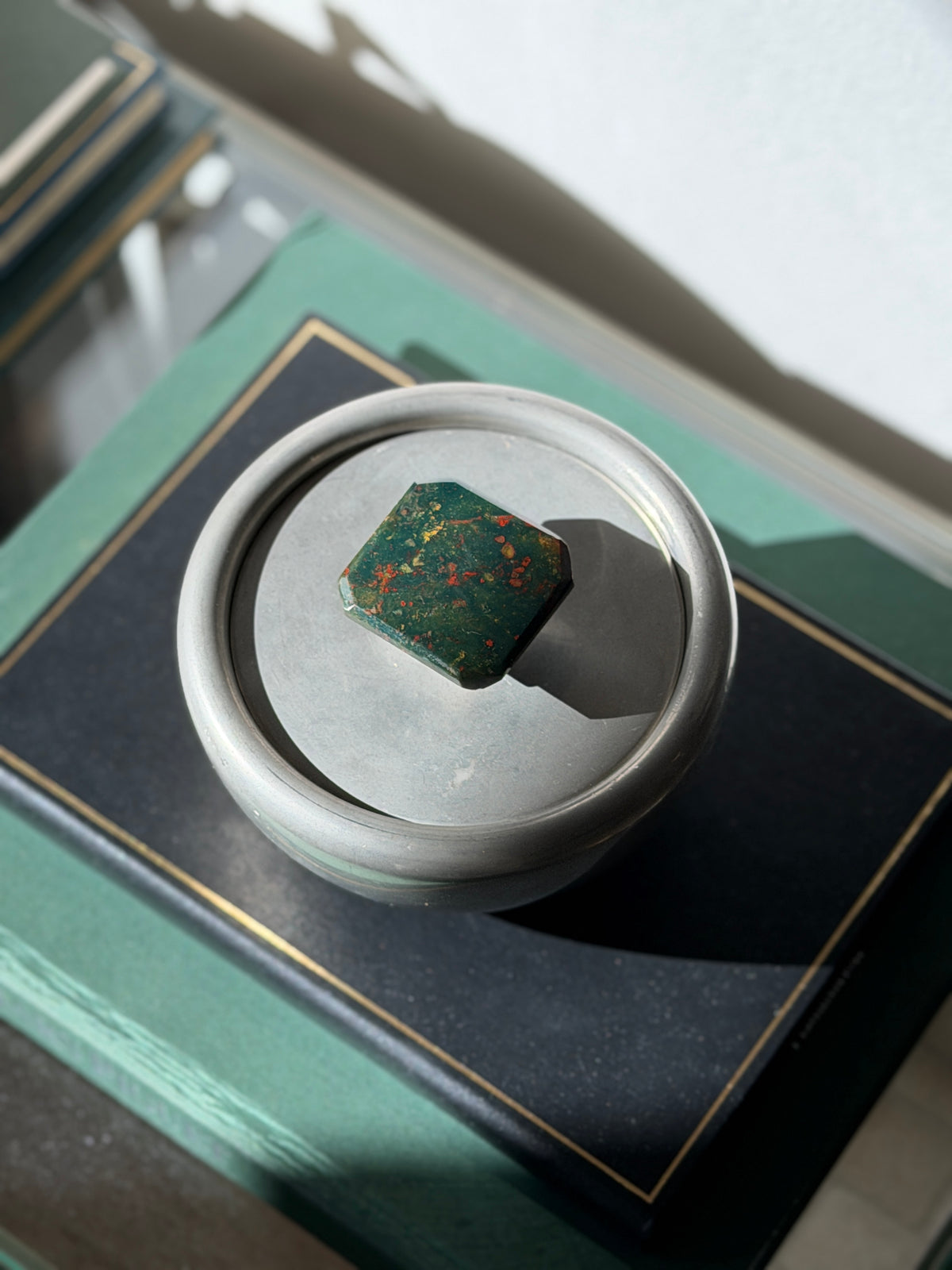 Top-down view of round Scandinavian pewter box with green bloodstone top available at Collectors Gene