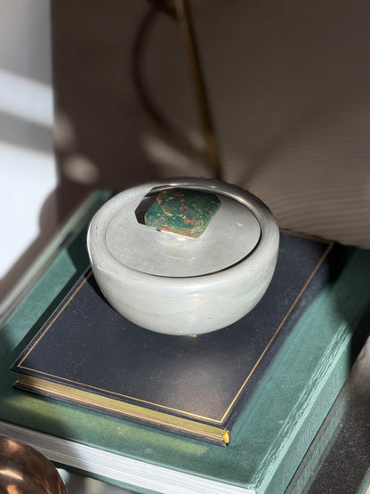 Vintage Svenskt Tenn pewter lidded bowl with bloodstone finial displayed on books from Collectors Gene