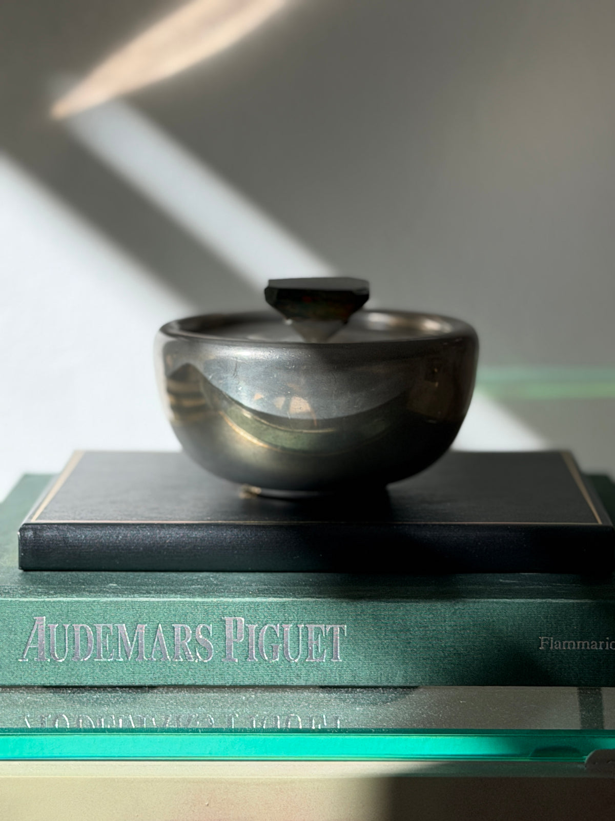 Curated shelf scene featuring Svenskt Tenn pewter and bloodstone decorative bowl at Collectors Gene