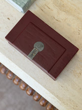 Top-down view of French Art Deco rectangular red leather box showing raised lid panel and silver hardware detail