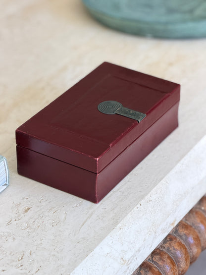 Collectors Gene vintage Puiforcat French Art Deco oxblood red leather decorative box with silver metal clasp on table