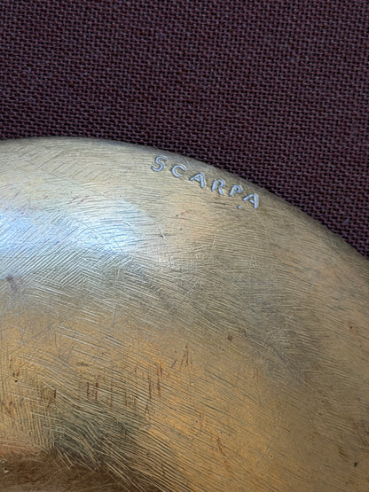 Underside of the bronze bowl showing the incised SCARPA signature near the rim and fine brushed tool marks