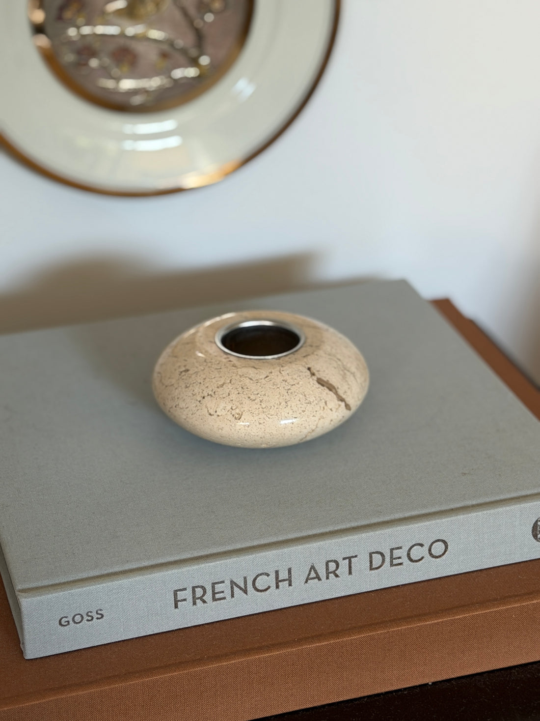 Collectors Gene vintage Italian cream travertine stone catchall tray displayed on a grey coffee table book