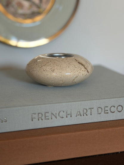 Low profile eye-level view of vintage 1970s solid travertine stone table lighter base used as small catchall