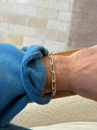 Bracelet worn on the wrist against a tiled brick wall background