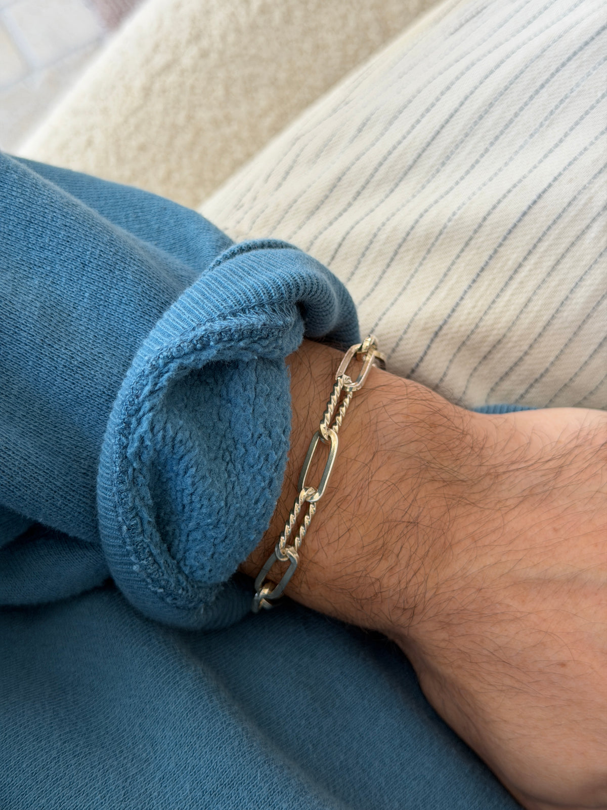 Bracelet worn on the wrist, another angle against a cream ribbed top