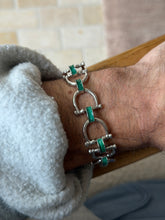Side view of the sterling silver links leading to the snaffle bit clasp