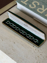 Top-down view of the coiled Bertuletti bracelet showing the enamel detail