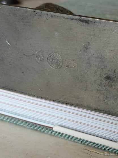 Macro close-up of the three hallmark stamps on the underside of the base plate