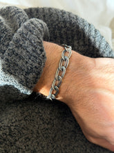Italian sterling silver bracelet of double wire oval links with an oxidized finish, worn on the wrist against a gray knit sleeve