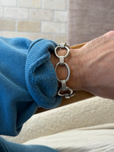Bracelet worn on the wrist against a tiled brick wall background