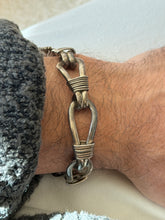 Close view of the sterling nautical bracelet, detailing the tightly coiled wire bindings where each pair of loops is lashed together