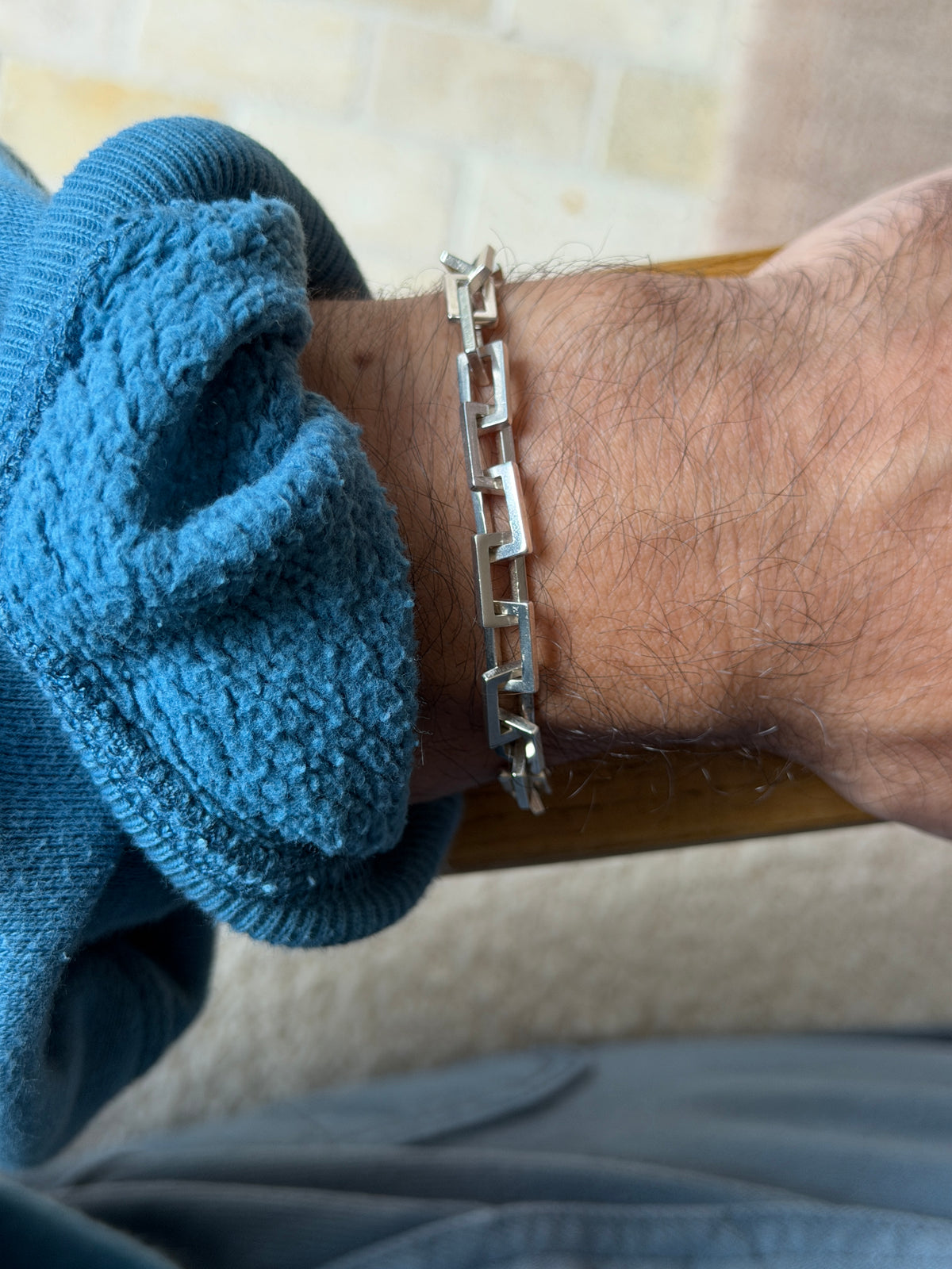 Straight on wrist view of the rectangle link bracelet, crisp geometric links catching soft daylight