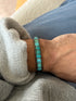 Cuff worn on the wrist against blue jeans and a grey sweatshirt cuff